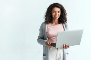 woman smiling while on computer